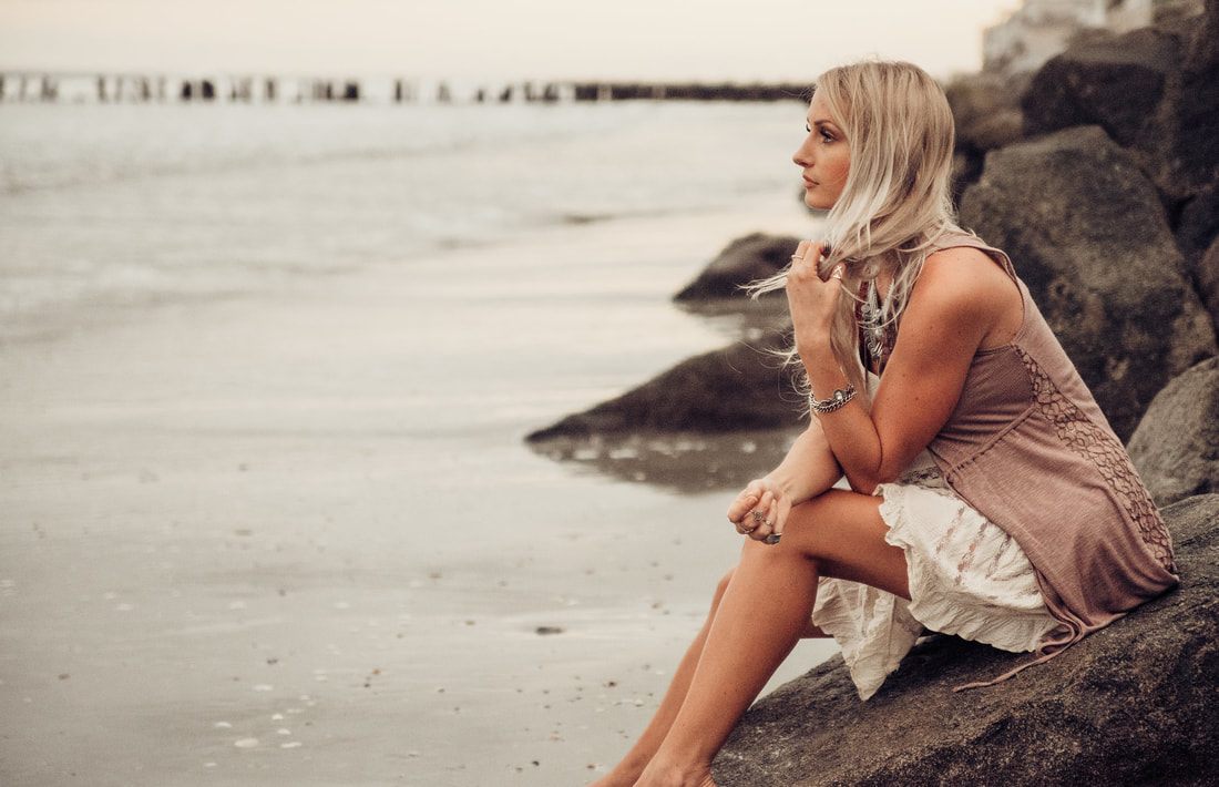 Portrait session on the sand at Folly Beach at sunset