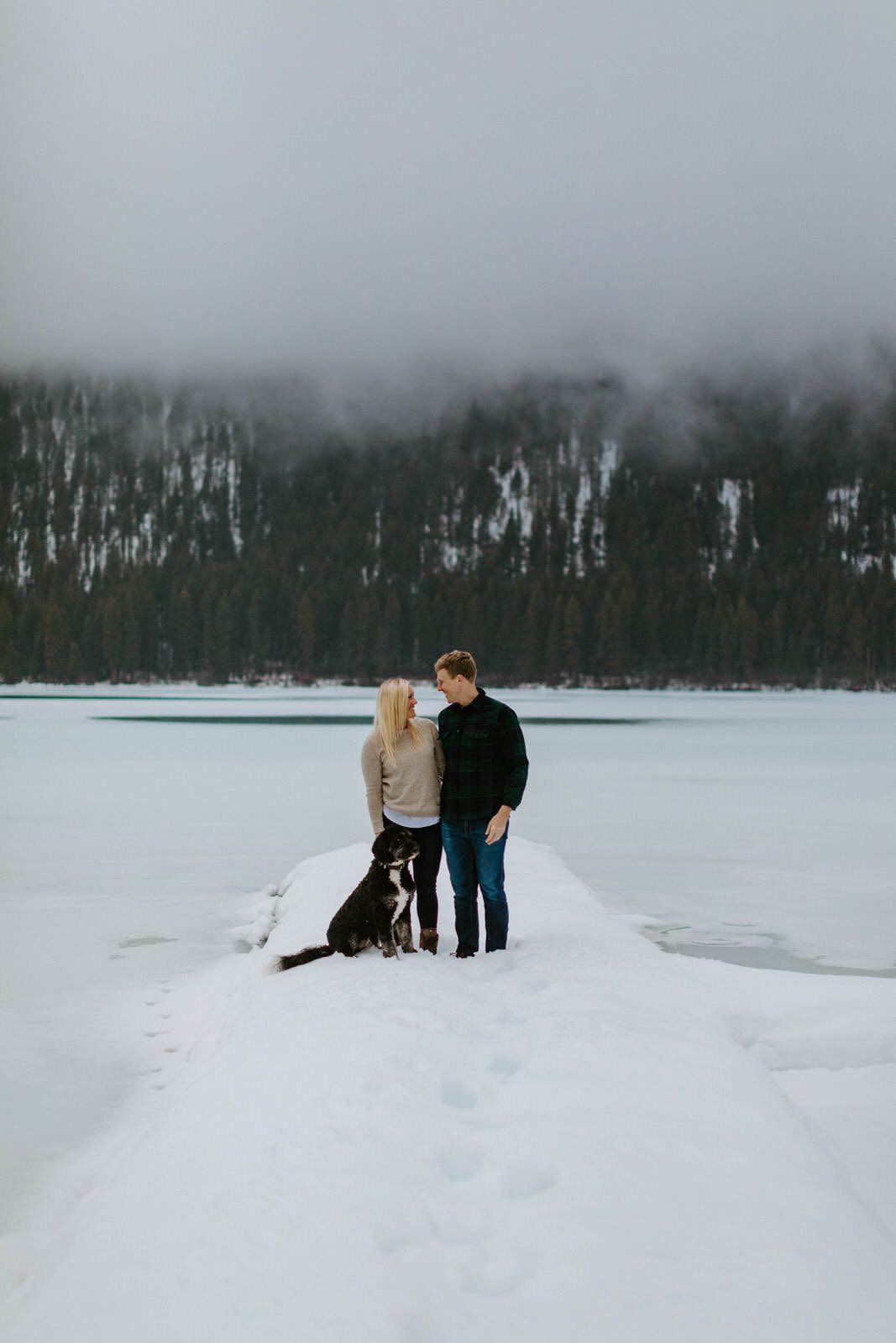 Husband and wife laughing together outside their Washington cabin