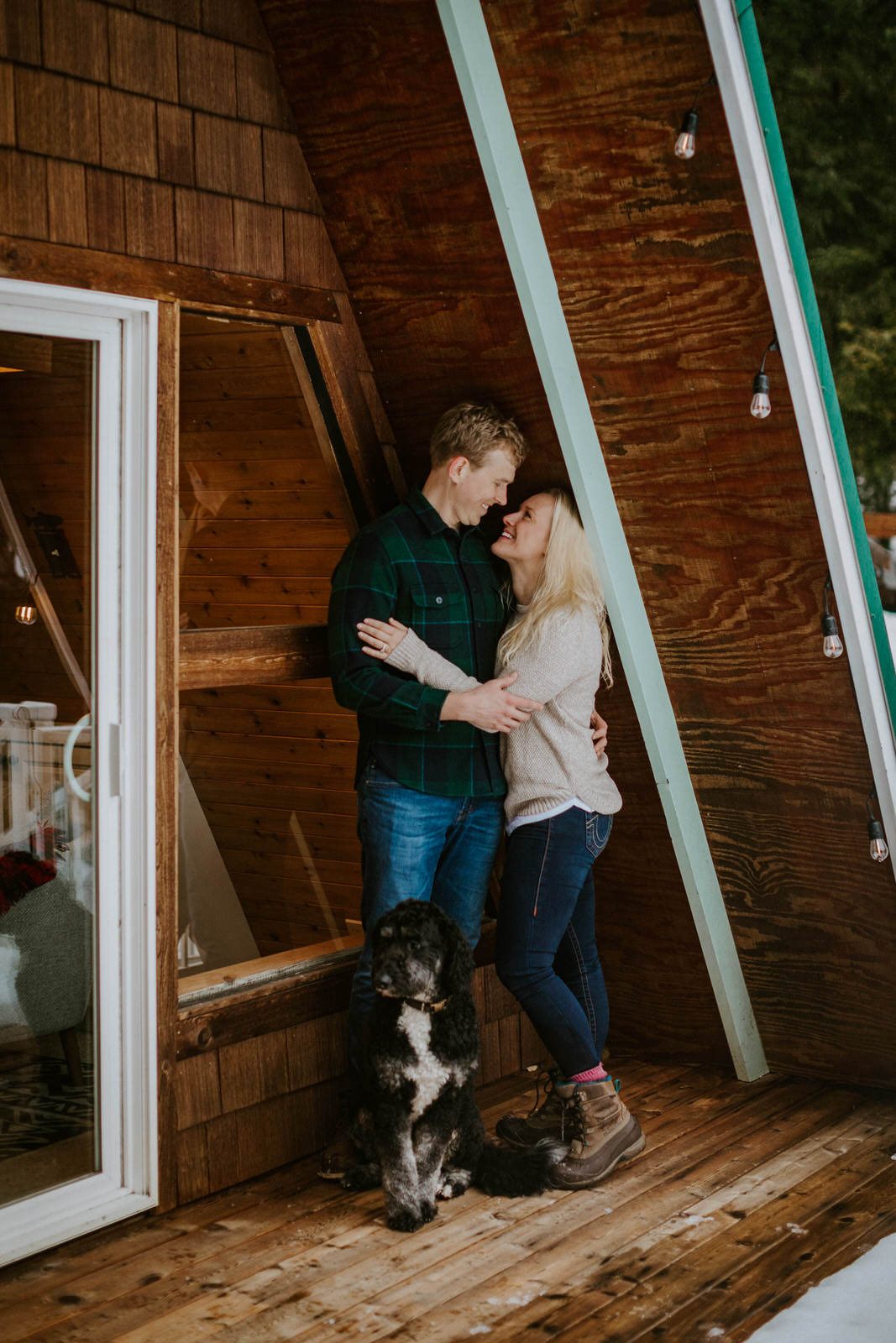 Couple laughing candidly during their cabin photo session