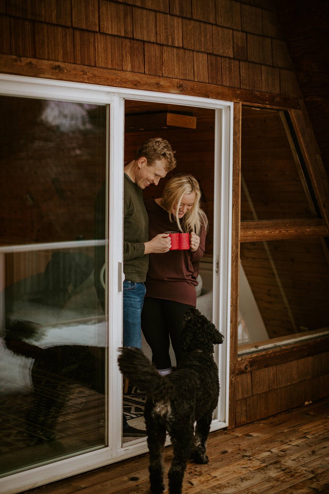 Couple sharing a laugh together outside their Washington cabin