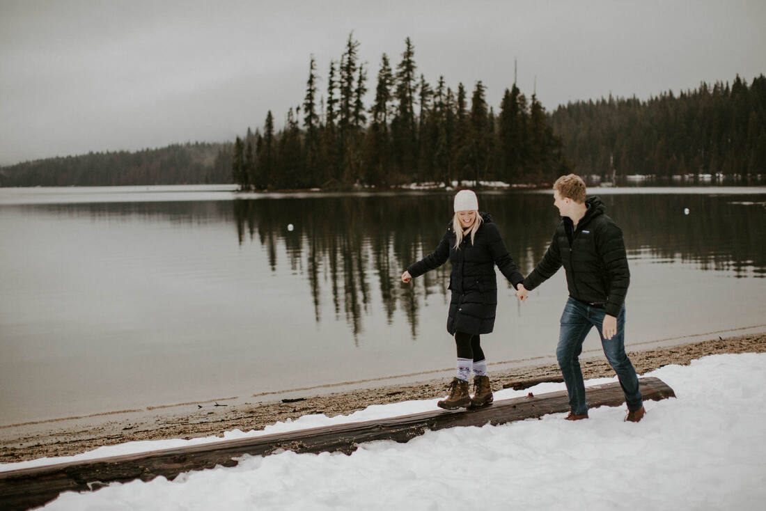 Husband and wife walking together through the pines near Lake Wenatchee