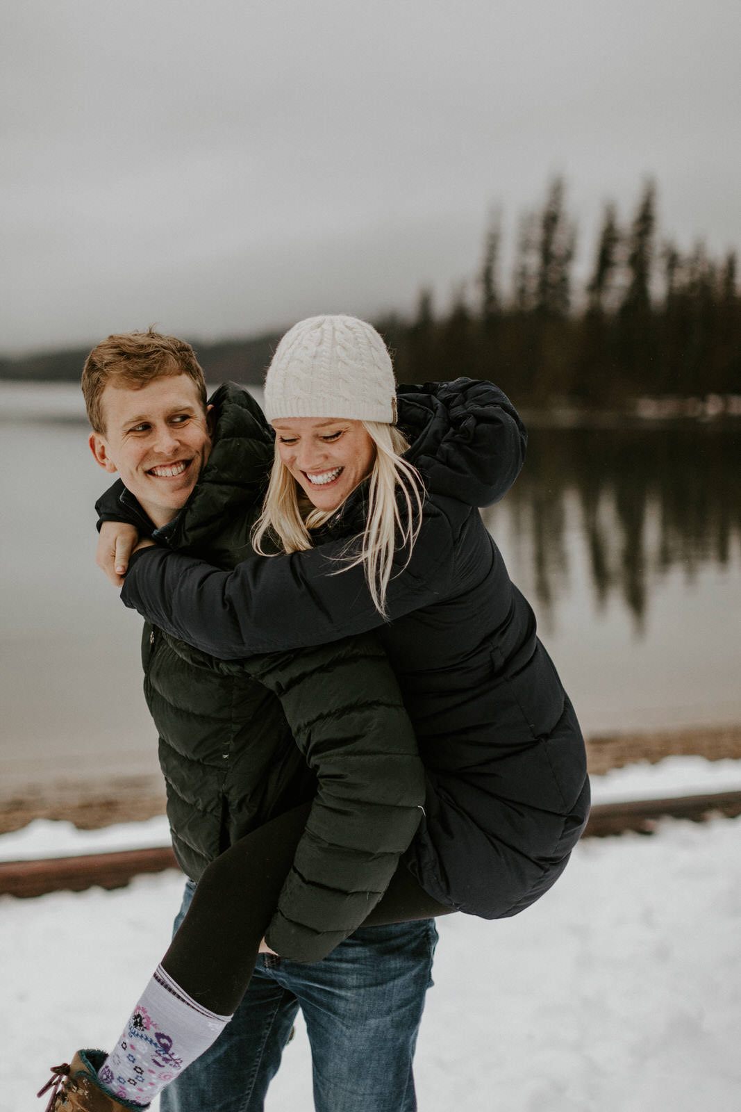 Couple standing together as golden light filters through the trees