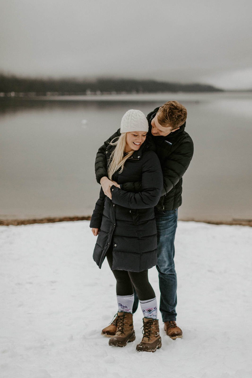 Close portrait of a couple smiling in front of their cabin