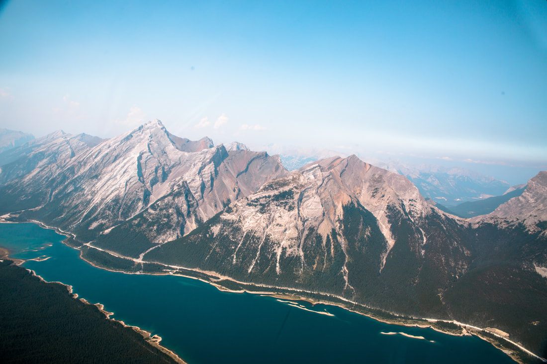 Snow-capped peaks above a turquoise lake in Banff, Alberta
