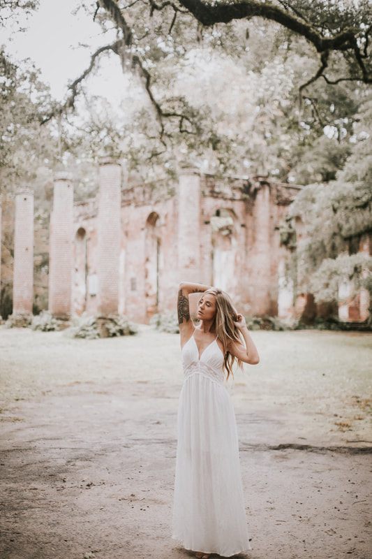 Charleston bridal portrait featuring dark red and purple floral styling with a moody, textured look.