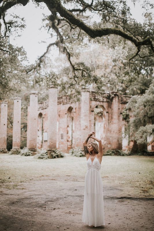 Bohemian bride holding a bouquet of succulents and cacti among the Sheldon Church Ruins near Charleston.