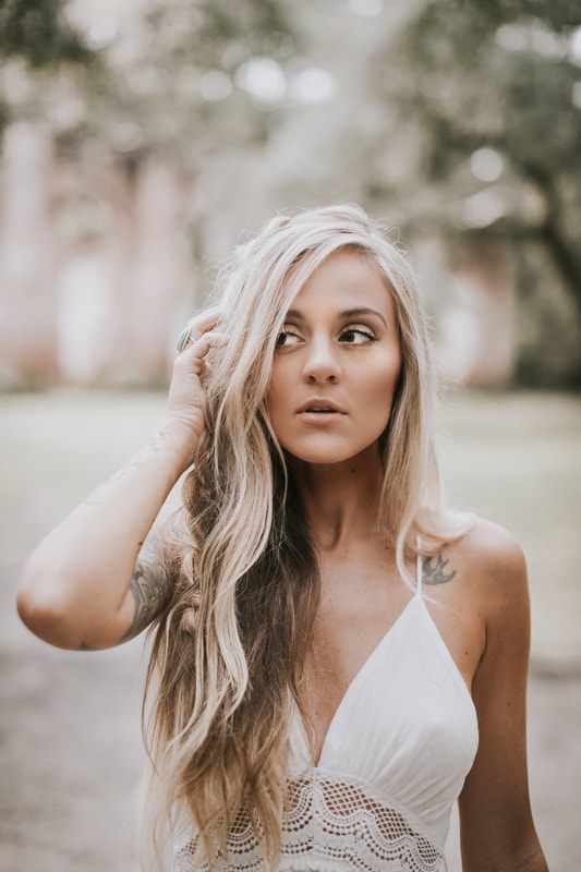 Bride posing among moss-draped oaks and crumbling columns at the Sheldon Church Ruins.