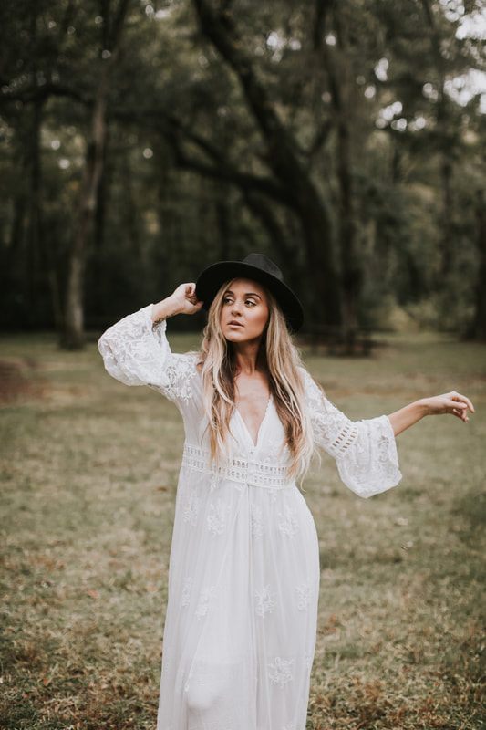 Bohemian bride holding a bouquet of succulents and cacti among the Sheldon Church Ruins near Charleston.