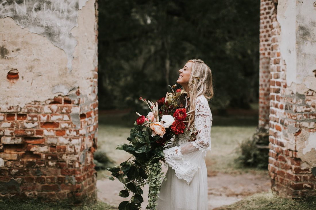 Bride posing among moss-draped oaks and crumbling columns at the Sheldon Church Ruins.