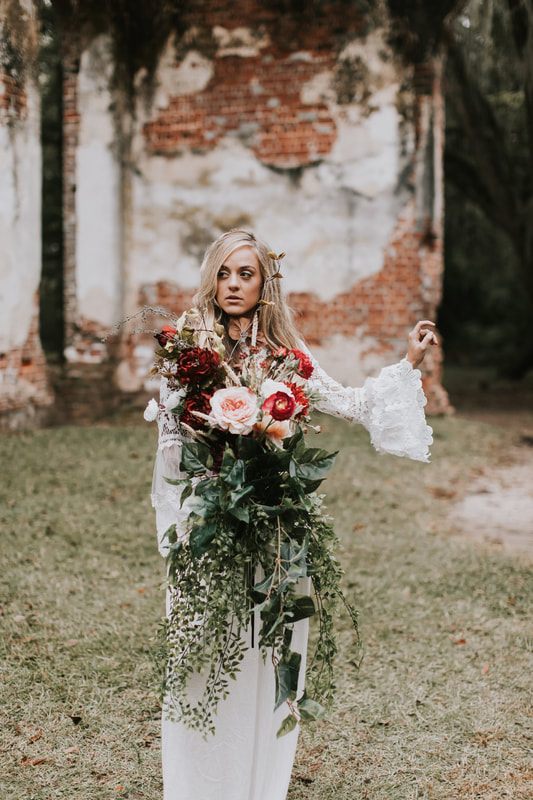 Artistic bridal portrait with dramatic natural light filtering through Charleston's oak canopy.