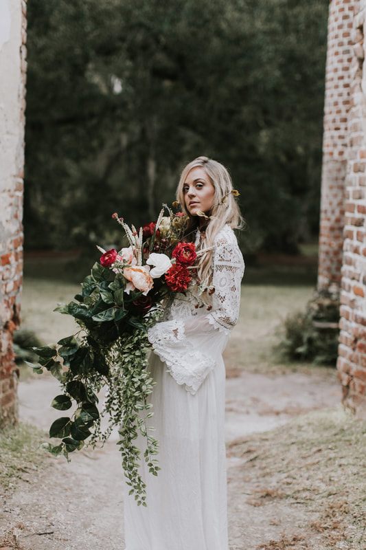 Charleston bridal portrait featuring dark red and purple floral styling with a moody, textured look.