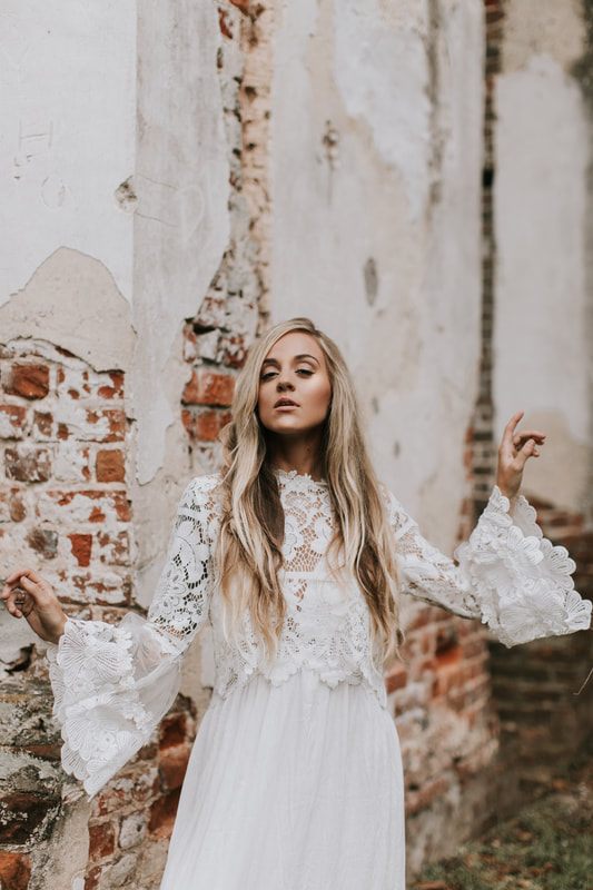 Bride posing among moss-draped oaks and crumbling columns at the Sheldon Church Ruins.