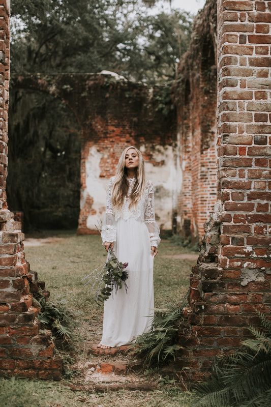 Bridal portrait highlighting the textured sleeve layer added over a simple white gown.