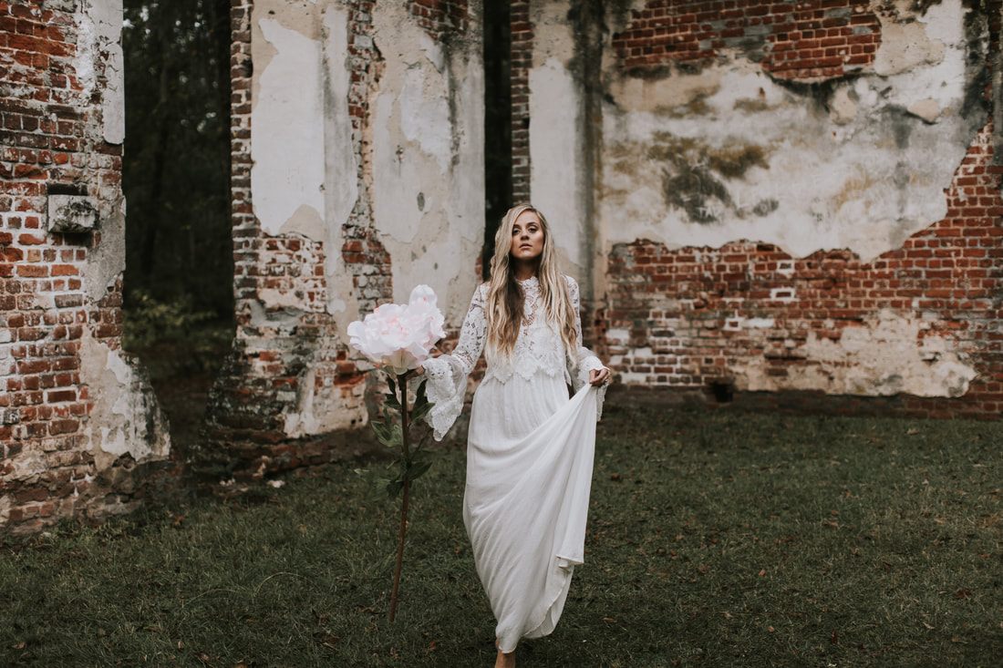 Artistic bridal portrait with dramatic natural light filtering through Charleston's oak canopy.