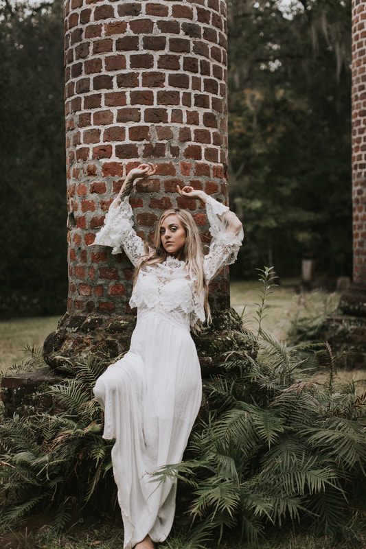 Charleston bridal portrait featuring dark red and purple floral styling with a moody, textured look.