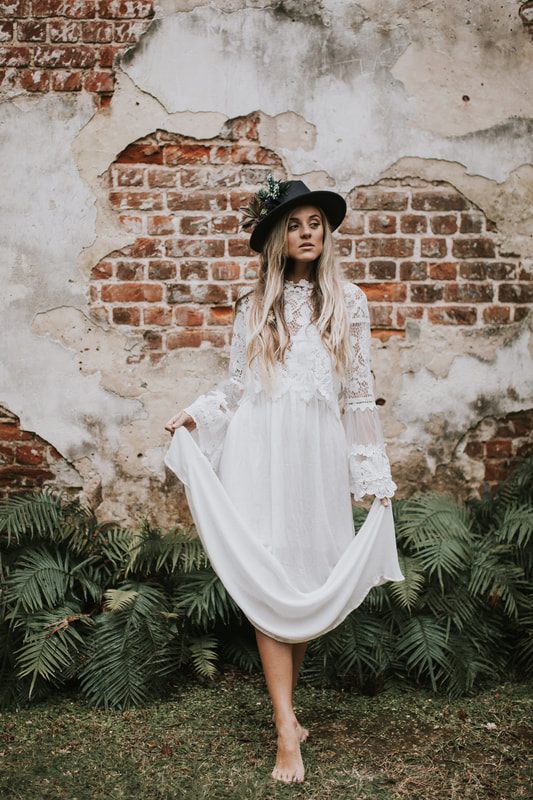 Bridal portrait highlighting the textured sleeve layer added over a simple white gown.