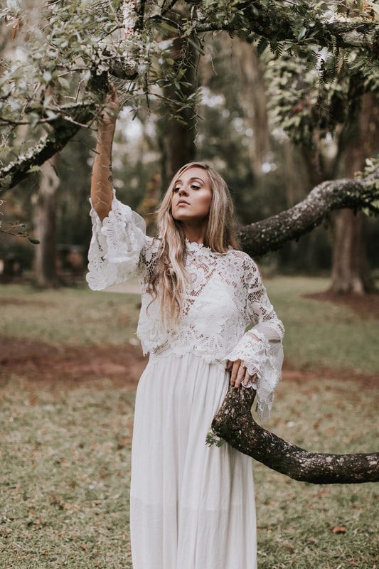 Bride posing among moss-draped oaks and crumbling columns at the Sheldon Church Ruins.