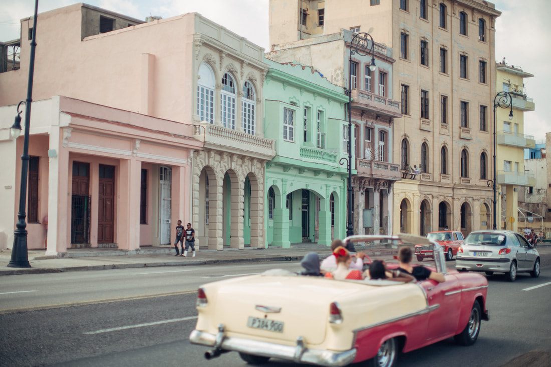 Classic 1950s car cruising the Malecon waterfront in Havana