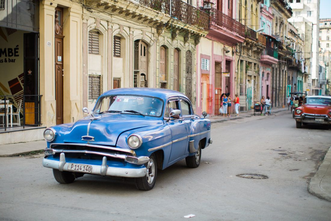 Local life on a narrow cobblestone street in Old Havana, Cuba
