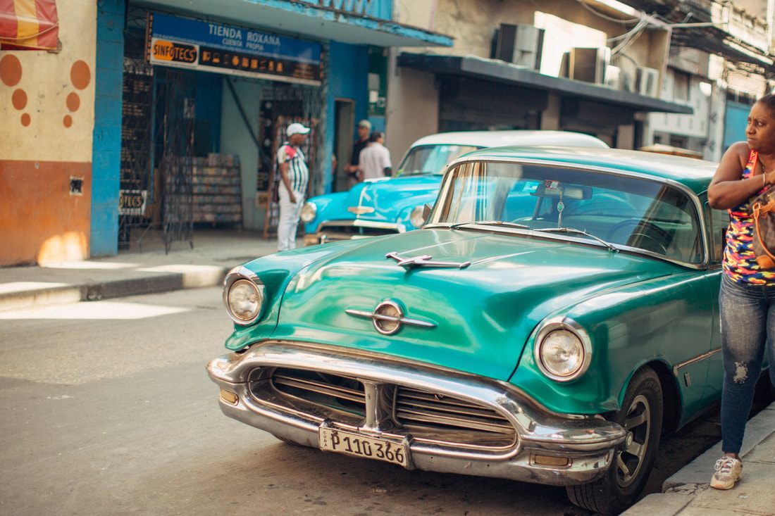 Close-up detail of a restored vintage car in Havana's colorful streets