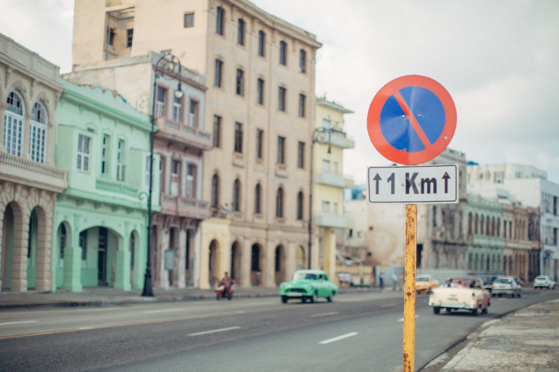 Local life on a narrow cobblestone street in Old Havana, Cuba