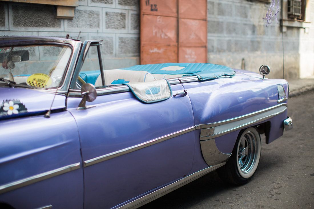 Local life on a narrow cobblestone street in Old Havana, Cuba
