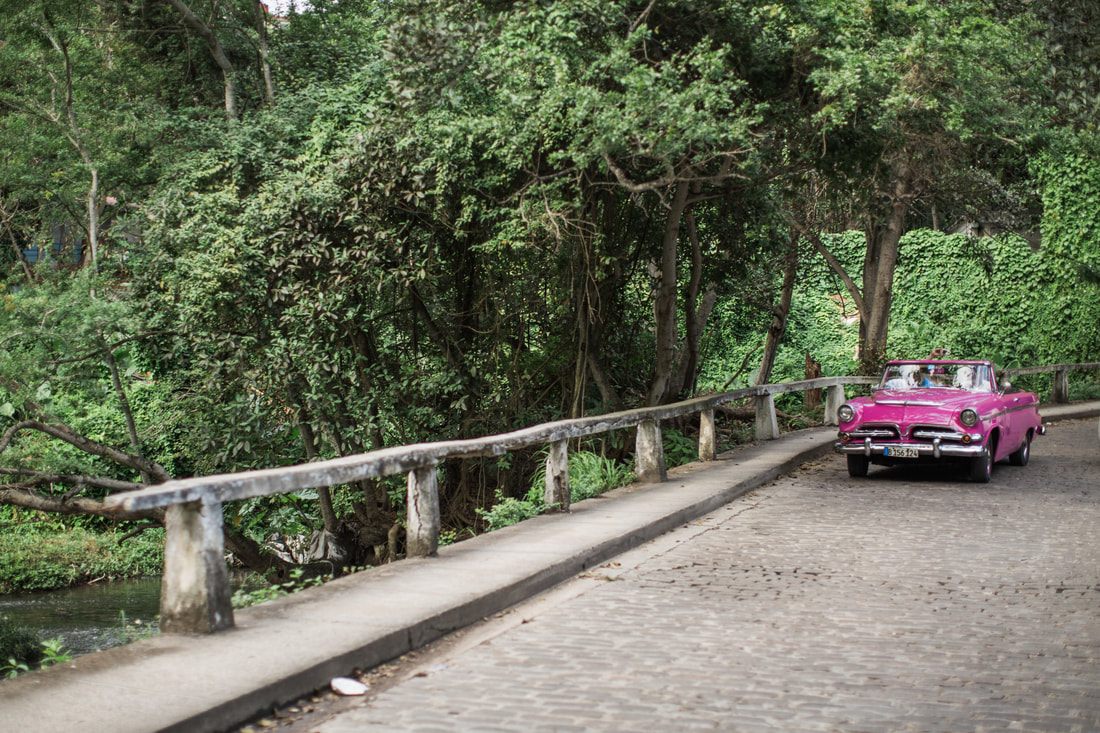 Local life on a narrow cobblestone street in Old Havana, Cuba