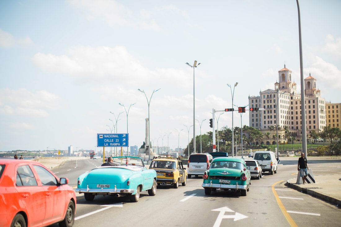 Classic 1950s car cruising the Malecon waterfront in Havana