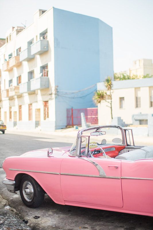 Close-up detail of a restored vintage car in Havana's colorful streets