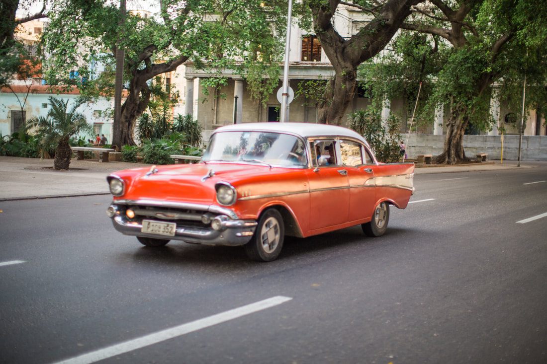 Classic 1950s car cruising the Malecon waterfront in Havana