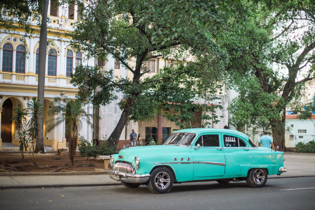 Local life on a narrow cobblestone street in Old Havana, Cuba