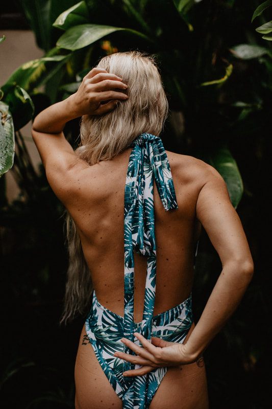 Walking through greenery in a Cheeky Swim one-piece near Sanur, Bali