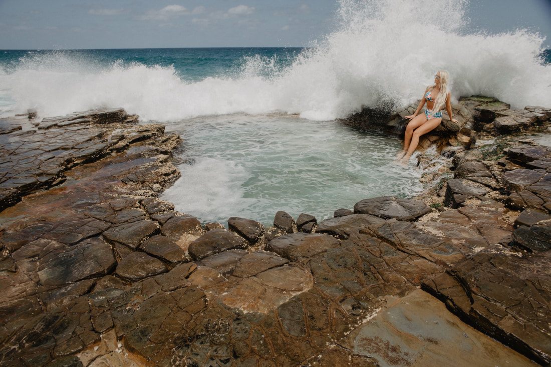 Woman posing in a Cheeky Swim high-waist bikini on the coastline near Sydney