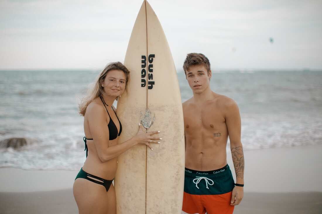 Angela and Bren laughing together in the surf on a San Diego beach
