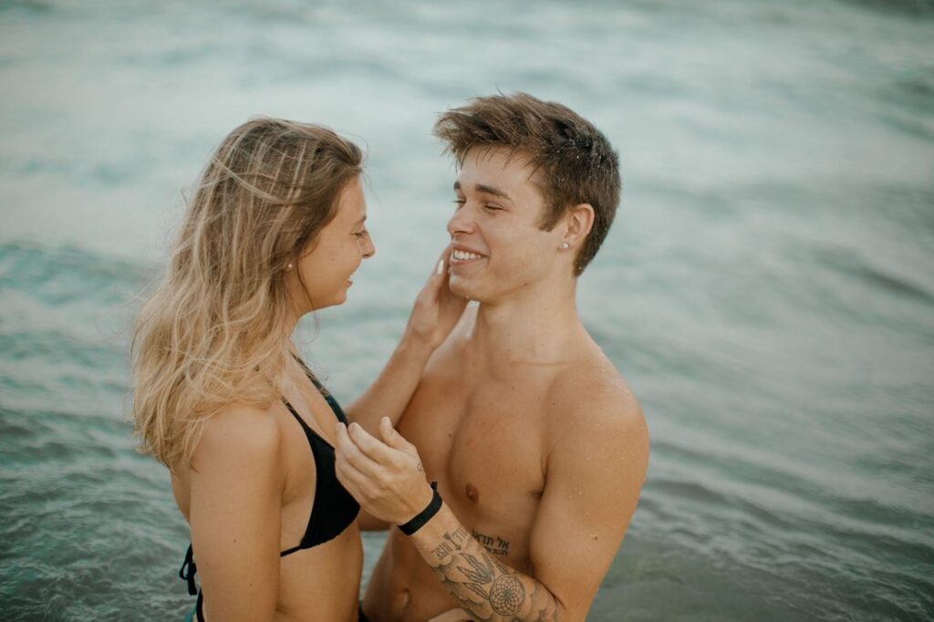 The two of them splashing in the salty water near the crashing surf