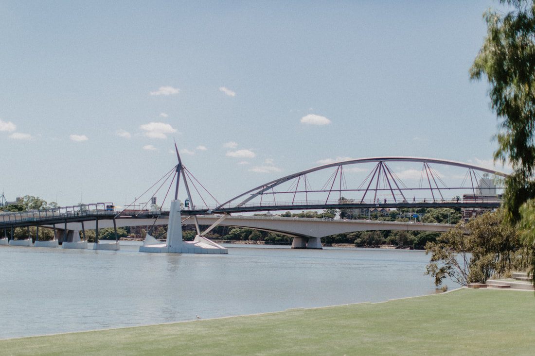 Photo of people relaxing on the lawn of a city park in Brisbane, Queensland, Australia