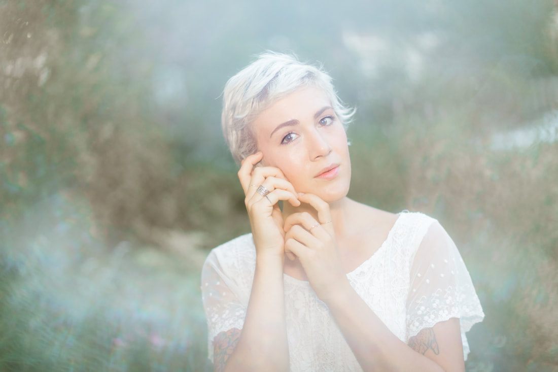 Airy portrait session featuring Charleston's historic downtown streets in the background.