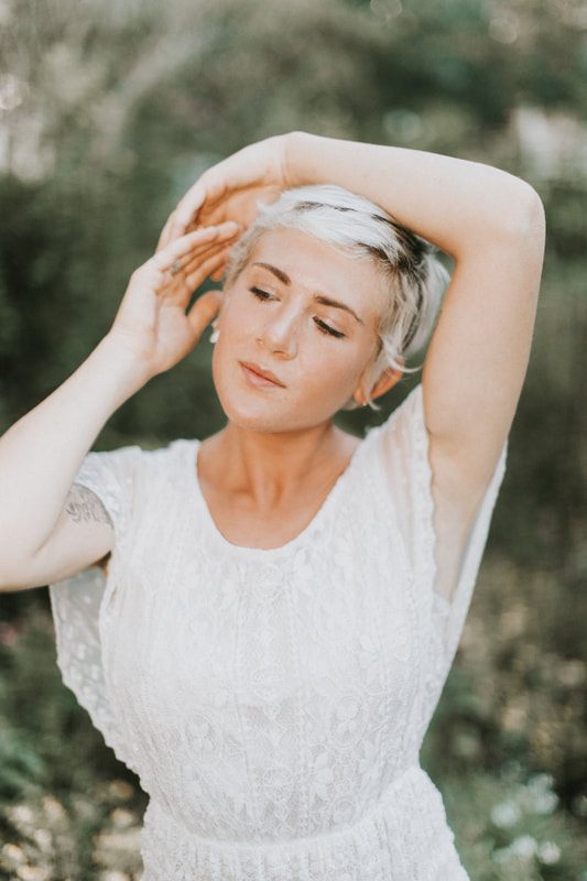 Downtown Charleston portrait with a bright, airy aesthetic and soft color palette.
