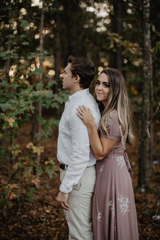 Chase and Mitch stand close together for a romantic engagement portrait.