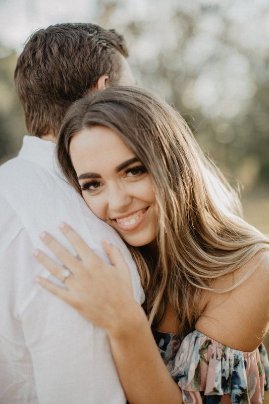 Chase and Mitch stand close together for a romantic engagement portrait.