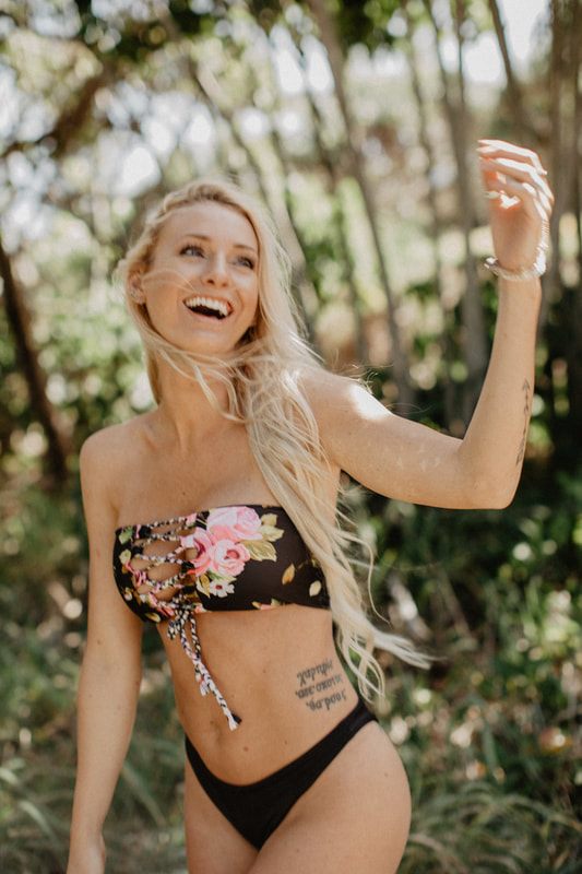 Candid beach portrait in a Cheeky Swim bikini along the Byron Bay coastline