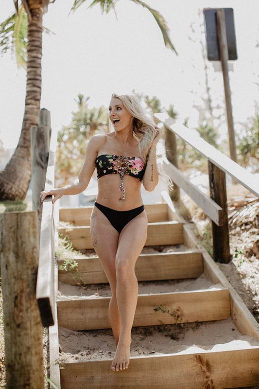 Candid beach portrait in a Cheeky Swim bikini along the Byron Bay coastline