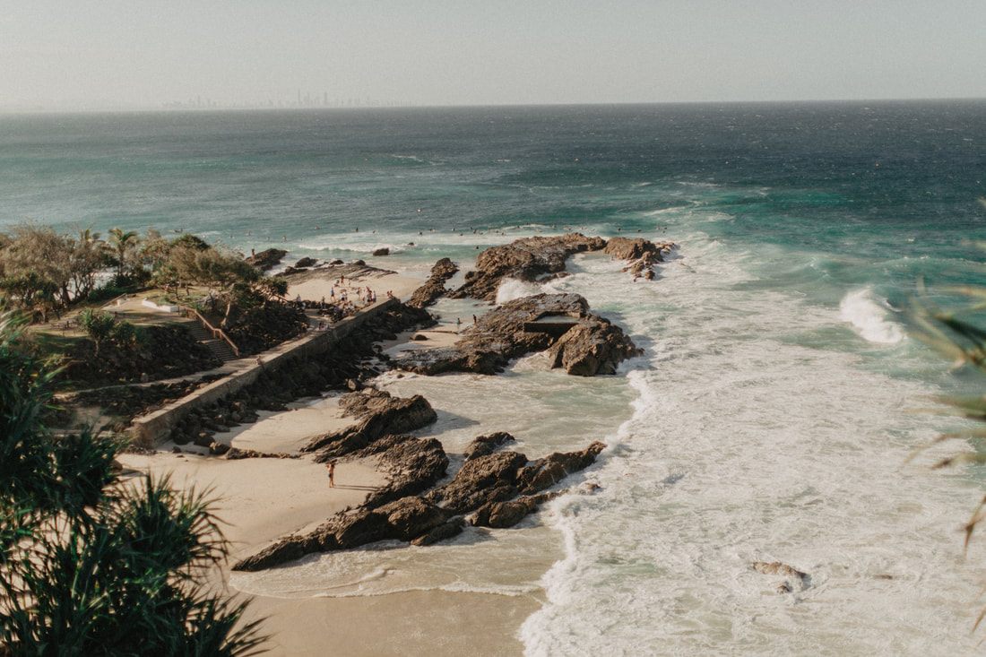 Photo of golden sand and turquoise surf along the Gold Coast between Brisbane and Byron Bay, Australia