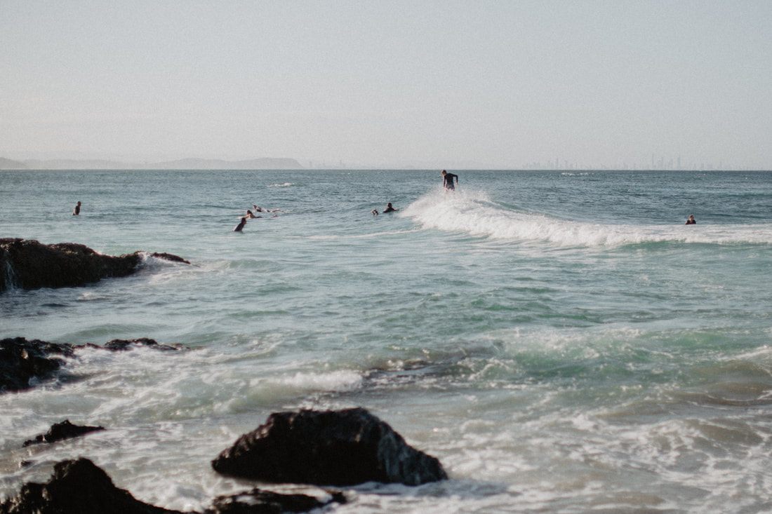 Photo of waves crashing against rocks along the drive from Brisbane to Byron Bay, Australia