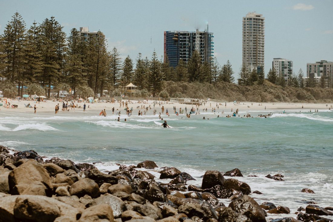 Photo of beachgoers relaxing on the sand near Byron Bay along the Gold Coast between Brisbane and Byron Bay, Australia