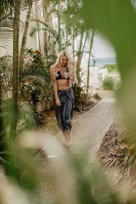 Walking along the shoreline in Strange Bikinis near Currumbin, Australia