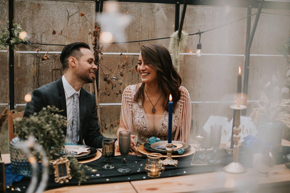 Couple embracing under string lights at their celestial-themed elopement