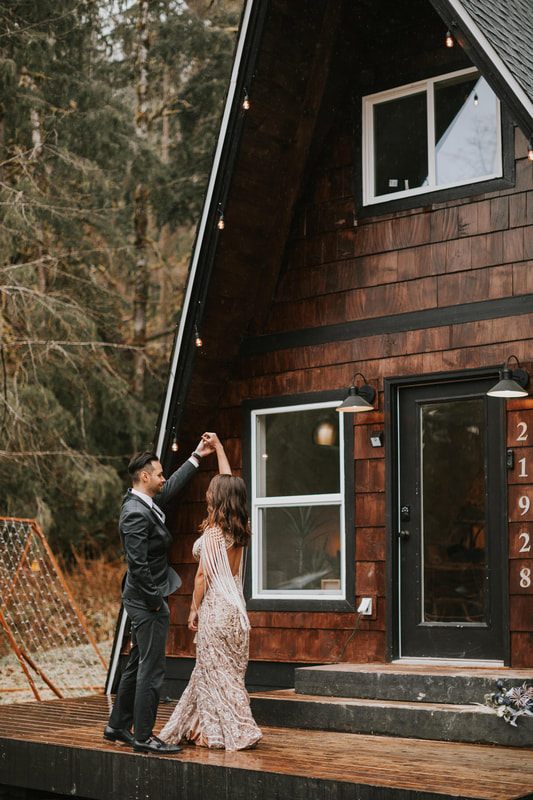 Couple embracing under string lights at their celestial-themed elopement