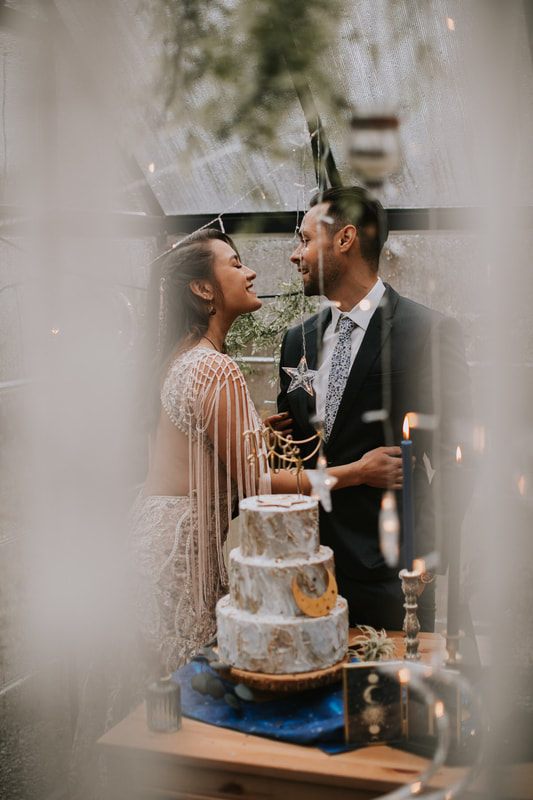 Couple sharing a first dance under twinkling lights at the cabin