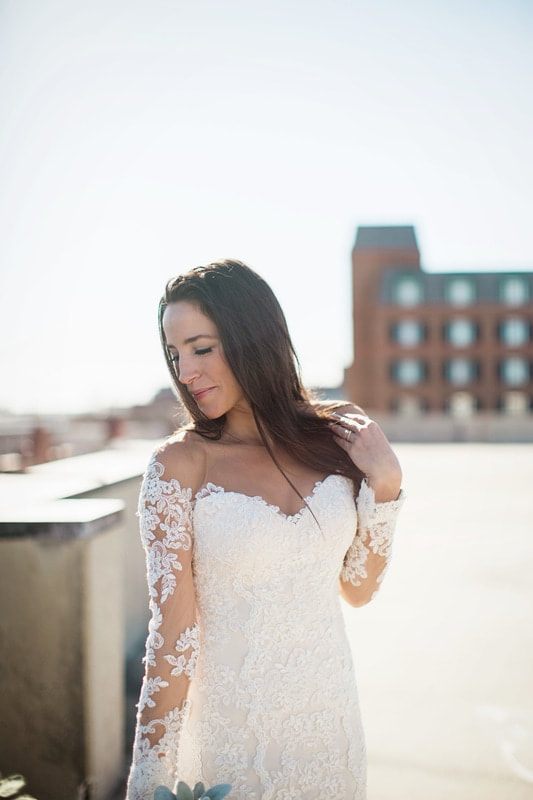 Full-length bridal portrait of Olivia in front of Charleston iron gates.